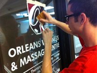 Orleans Wellness and Massage  Installation of cut vinyl and printed logo on front door